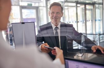Пошаговый порядок обжалования штрафов с камер ГИБДД 32 cheerful mature man in elegant suit is giving documents for checking in to female officer at desk
