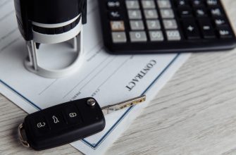 purchase agreement for a car with contract stamp calculator and key close up concept for sale car