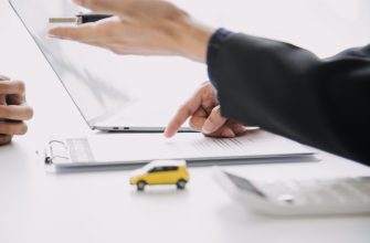 Как расшифровывается ОСАГО и что это такое 17 man signing car insurance document lease paper writing signature contract agreement buying selling new used vehicle car keys table warranty guarantee customer salesman